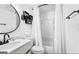 Clean bathroom with modern black fixtures, white vanity, toilet, and tub with shower at 6490 Cainwood Dr, Atlanta, GA 30349