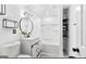 Bathroom featuring modern fixtures, stylish mirror, and convenient storage shelves in a well-lit space at 6490 Cainwood Dr, Atlanta, GA 30349