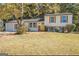 Charming two-story home with a well-maintained front yard and a welcoming yellow front door at 6490 Cainwood Dr, Atlanta, GA 30349