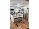 Well-lit kitchen with white cabinets, granite countertops, stainless appliances, and a central island at 6490 Cainwood Dr, Atlanta, GA 30349