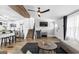 Open concept living room and kitchen with hardwood floors and modern lighting at 6490 Cainwood Dr, Atlanta, GA 30349
