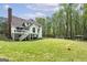 Expansive backyard with lush lawn, deck, and plenty of trees at 20 Allie Dr, Mcdonough, GA 30252