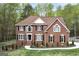 Charming brick home featuring black shutters, manicured landscaping and curved windows at 20 Allie Dr, Mcdonough, GA 30252