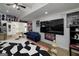 Large, brightly lit recreation room with hardwood floors, a ceiling fan, and a variety of decor at 20 Allie Dr, Mcdonough, GA 30252