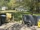 Green backyard with detached shed, garage and wooden deck at 579 Wexwood Dr, Riverdale, GA 30274