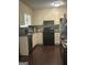 Functional kitchen featuring dark wood floors, granite countertops, and appliances at 579 Wexwood Dr, Riverdale, GA 30274