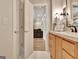 Hallway with a view to the bathroom with a wood vanity, marble floor and modern fixtures at 285 Broadmoor Dr, Fayetteville, GA 30215