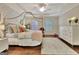 A well lit bedroom features a canopy bed, neutral decor, and wood floors at 285 Broadmoor Dr, Fayetteville, GA 30215