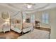 A well lit bedroom features decorative wallpaper, neutral decor, and wood floors at 285 Broadmoor Dr, Fayetteville, GA 30215