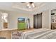 Bright bedroom with an ensuite bathroom, unique sliding doors, green cabinet, and stylish rug at 285 Broadmoor Dr, Fayetteville, GA 30215