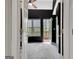 View through doorway to a bedroom with black walls, a ceiling fan, carpet, and a door to a deck at 285 Broadmoor Dr, Fayetteville, GA 30215