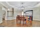Dining area featuring hardwood floors, elegant table and chairs, and custom cabinetry at 285 Broadmoor Dr, Fayetteville, GA 30215