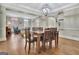 Dining room with hardwood flooring, a chandelier, and an elaborate wood table with chairs at 285 Broadmoor Dr, Fayetteville, GA 30215