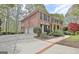 Traditional brick home with manicured landscaping, a spacious driveway, and a two-car garage at 285 Broadmoor Dr, Fayetteville, GA 30215