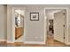 Hallway featuring views to the bathroom with a wood vanity and the den with beverage cooler at 285 Broadmoor Dr, Fayetteville, GA 30215