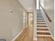 Hallway with hardwood floors leads to a staircase and a bright, inviting space at 285 Broadmoor Dr, Fayetteville, GA 30215