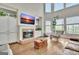 Cozy living room with a brick fireplace, built-in shelves, and high ceilings at 285 Broadmoor Dr, Fayetteville, GA 30215