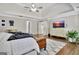 Comfortable main bedroom with hardwood floors, a stylish rug, and a large television at 285 Broadmoor Dr, Fayetteville, GA 30215