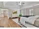 Bright main bedroom with hardwood floors, a decorative rug, and a large entertainment center at 285 Broadmoor Dr, Fayetteville, GA 30215