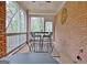 Cozy screened porch with brick accent wall and a table with chairs at 285 Broadmoor Dr, Fayetteville, GA 30215