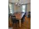 Bright dining room featuring hardwood floors, a chandelier, and natural light from two windows at 4365 Newton Cir, Douglasville, GA 30134