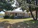 Charming one-story home with tan siding, mature trees, and a welcoming front porch at 4365 Newton Cir, Douglasville, GA 30134