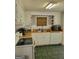 Functional kitchen with white cabinets, neutral countertops, and green tile flooring at 4365 Newton Cir, Douglasville, GA 30134