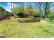 Green lawn with tiered retaining walls and wooden fence at 2940 Parkridge Ne Dr, Brookhaven, GA 30319