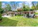 Spacious backyard with a patio area, outdoor seating, a fire pit, a grill, and a lush lawn at 2940 Parkridge Ne Dr, Brookhaven, GA 30319