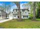 Charming two-story home featuring a well-manicured lawn, classic architectural details, and mature trees at 2940 Parkridge Ne Dr, Brookhaven, GA 30319