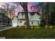 Charming two-story home with a well-manicured lawn, mature trees, and a driveway at 2940 Parkridge Ne Dr, Brookhaven, GA 30319