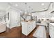 Modern kitchen with a central island, stainless steel appliances, and a view towards the staircase and living space at 2940 Parkridge Ne Dr, Brookhaven, GA 30319