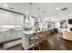 Bright, open kitchen featuring a large island with seating, modern white cabinets, and stainless steel appliances at 2940 Parkridge Ne Dr, Brookhaven, GA 30319