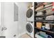 Laundry room featuring stacked washer and dryer and a storage rack with towels and linens at 2940 Parkridge Ne Dr, Brookhaven, GA 30319