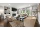 Cozy living room featuring a white brick fireplace, built-in bookshelves, and large windows for natural light at 2940 Parkridge Ne Dr, Brookhaven, GA 30319