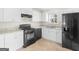 Functional kitchen with white cabinets and black appliances at 1508 Bonanza Church Rd, Jonesboro, GA 30238