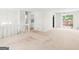Spacious, neutral open-concept living room with sliding glass door to deck at 1508 Bonanza Church Rd, Jonesboro, GA 30238