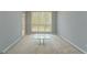 Bright living room featuring neutral walls and carpet with an open window at 12711 Simmons Rd, Hampton, GA 30228