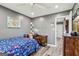 Bedroom with hardwood style flooring, a ceiling fan, and natural light from the window at 2014 Big Cypress Ln, Locust Grove, GA 30248