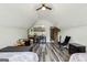 Upstairs bedroom has hardwood floors, a large window, entertainment, and seating at 2014 Big Cypress Ln, Locust Grove, GA 30248