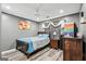Comfortable bedroom with gray walls, ceiling fan, and a wooden bed frame at 2014 Big Cypress Ln, Locust Grove, GA 30248