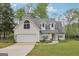 Charming home with a two-car garage, dormer windows, and a well-maintained lawn with mature trees at 2014 Big Cypress Ln, Locust Grove, GA 30248
