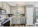 Updated kitchen featuring stainless appliances, granite countertops, and hardwood style flooring at 2014 Big Cypress Ln, Locust Grove, GA 30248