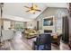 Open living space with vaulted ceilings, a fireplace, large windows, and access to the dining area at 2014 Big Cypress Ln, Locust Grove, GA 30248