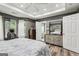Main bedroom featuring hardwood floors, sitting area, and tray ceilings with recessed lights at 2014 Big Cypress Ln, Locust Grove, GA 30248