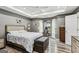 Main bedroom featuring hardwood floors, sitting area, and tray ceilings with recessed lights at 2014 Big Cypress Ln, Locust Grove, GA 30248