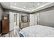 Main bedroom featuring hardwood floors, sitting area, and tray ceilings with recessed lights at 2014 Big Cypress Ln, Locust Grove, GA 30248
