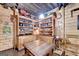 Cozy basement library with wood-paneled walls and built-in bookshelves and a wooden table at 3230 Riverhill Ct, Cumming, GA 30041