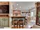 Breakfast bar featuring wooden stools and an open view to the kitchen and dining area at 3230 Riverhill Ct, Cumming, GA 30041