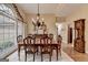 Elegant dining room featuring a large window, chandelier, and classic furniture at 3230 Riverhill Ct, Cumming, GA 30041